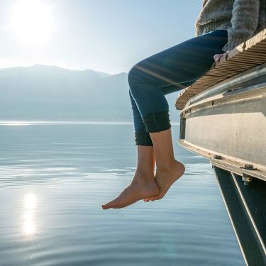 Image: bare feet by a lake